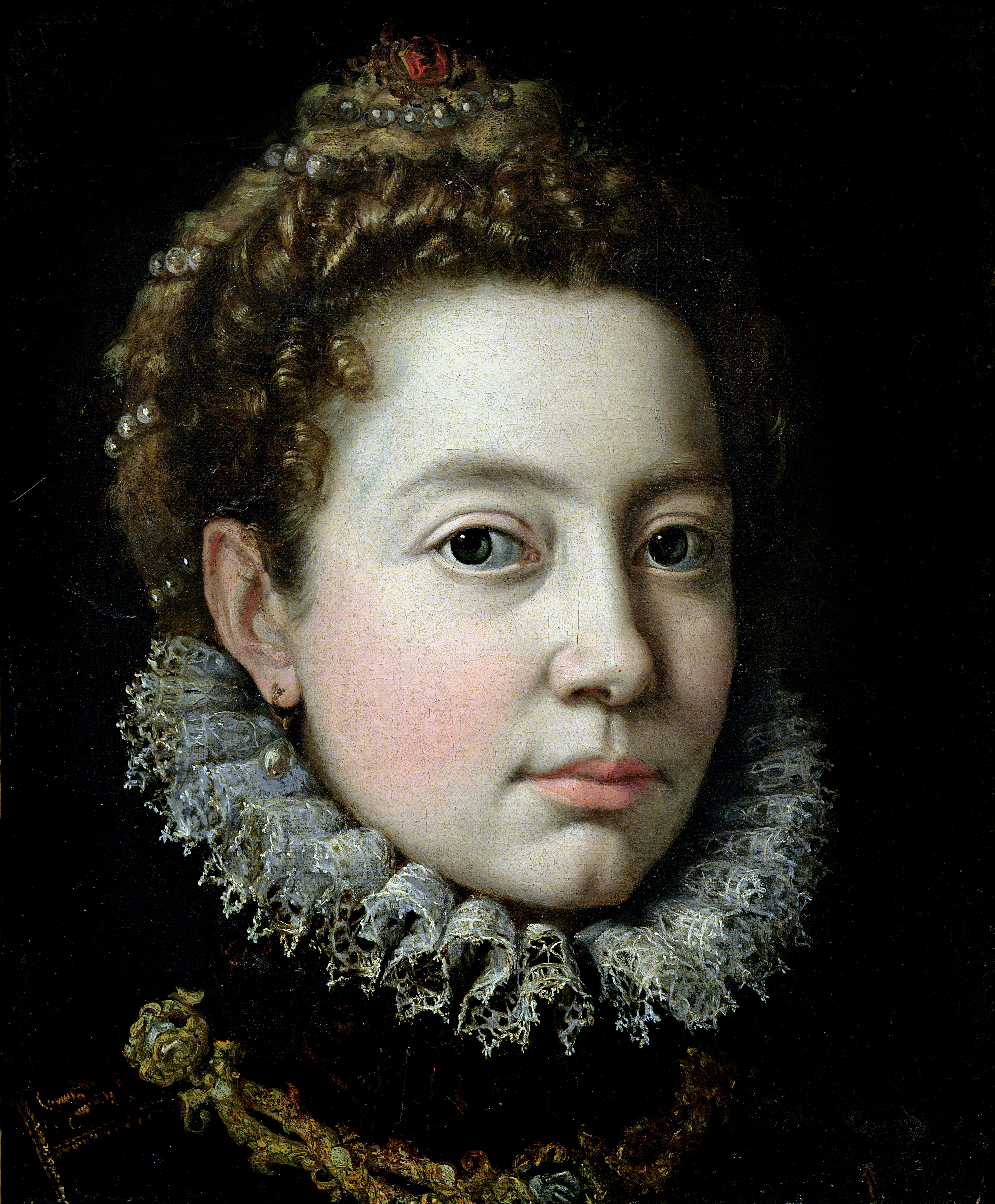 A painting shows a woman from the bust up, gazing directly at the viewer. She wears pearl earrings and an elaborate headband adorned with pearls and topped by a small tiara. She also wears a gorget, a large, round, wheel-like collar of pleated fine linen.
