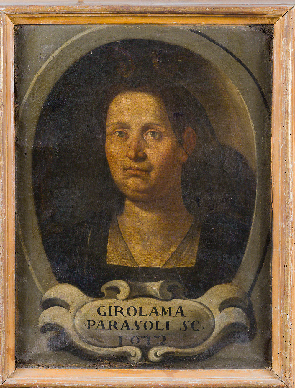 A painting shows a woman from the bust up, gazing directly at the viewer. She wears black and a widow's veil. Her figure is set within a medallion-like frame that appears inside the larger frame of the image. A cartouche is inscribed with another variant of her name: “Girolama Parasoli Sc./1612.”